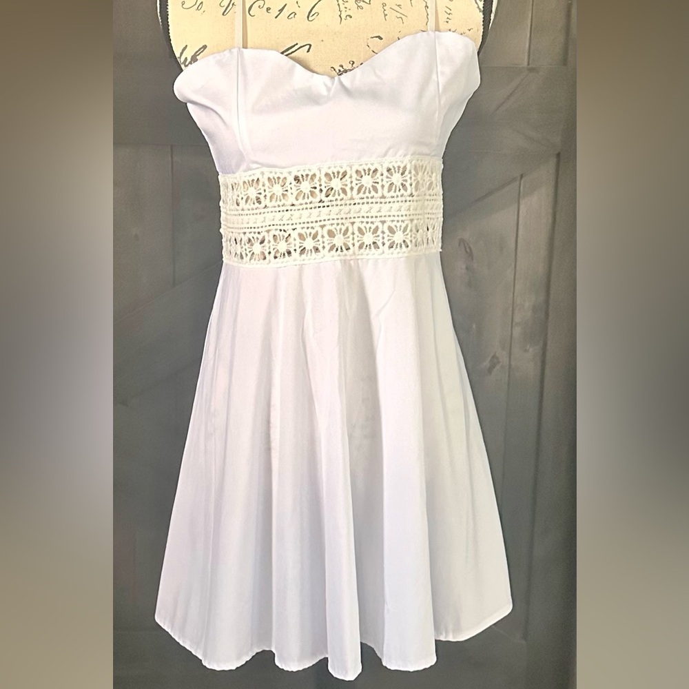 White spaghetti strap mini dress with crochet center and back zipper enclosure.